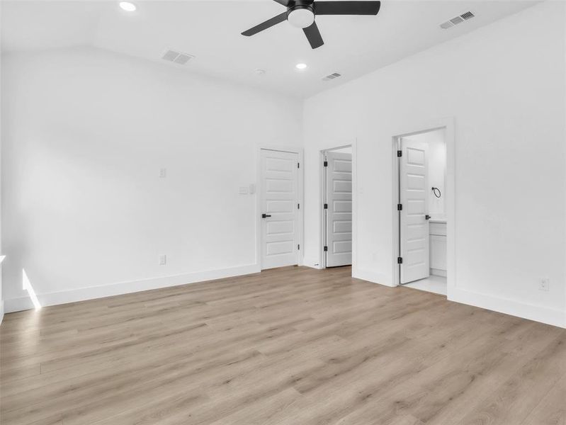 Unfurnished bedroom featuring light wood-style floors, visible vents, and recessed lighting Unfurnished bedroom featuring light wood-style floors, visible vents, and recessed lighting