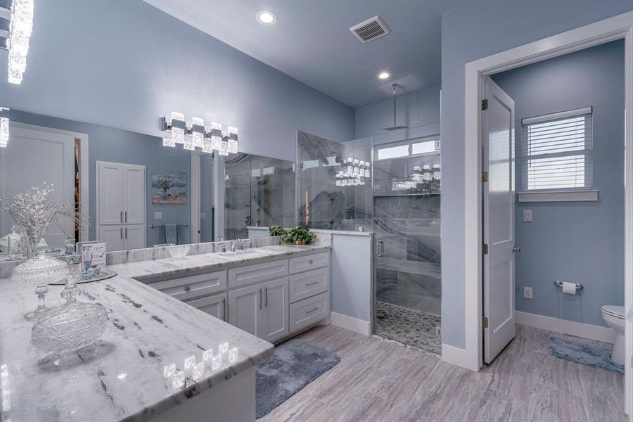 Bathroom with granite countertops and designer lighting