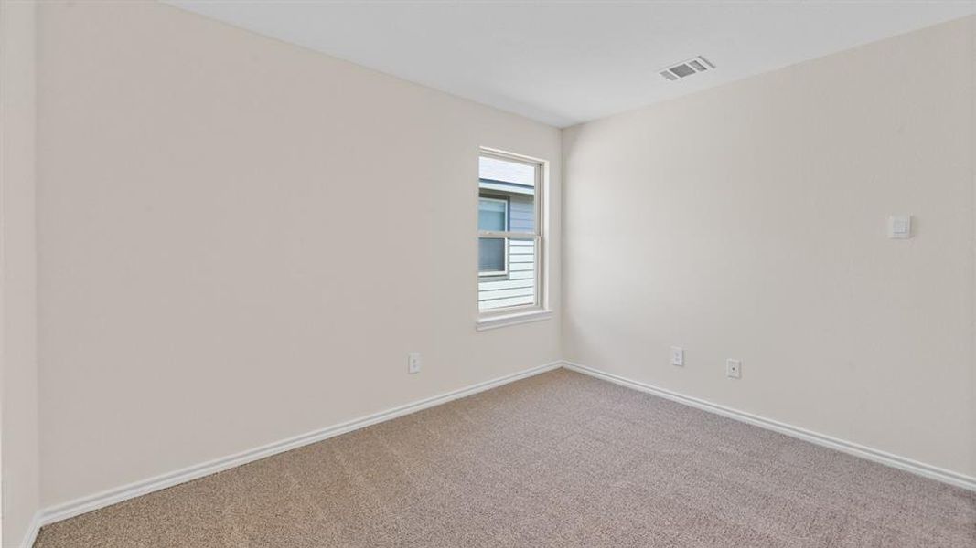 Neutral tone walls with white trim and light-colored carpet