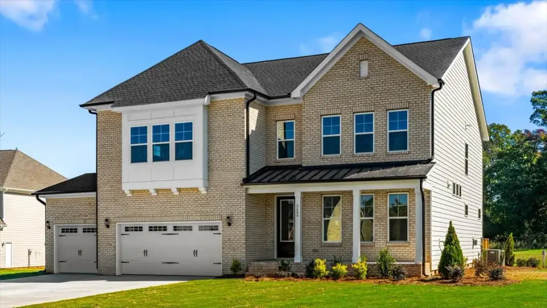 Front exterior of a new home in Lilah Grove, Summerfield, NC, highlighting curb appeal (Image 2). Front exterior of a new home in Lilah Grove, Summerfield, NC, highlighting curb appeal (Image 2).