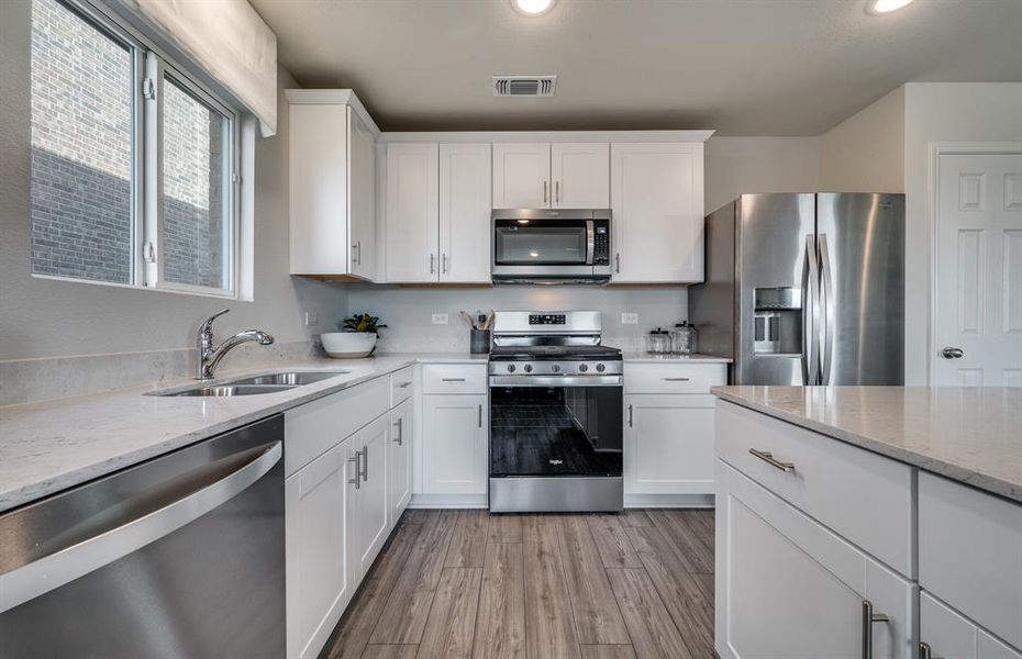 Kitchen featuring a large island ideal for informal dining and gatherings *Model representation