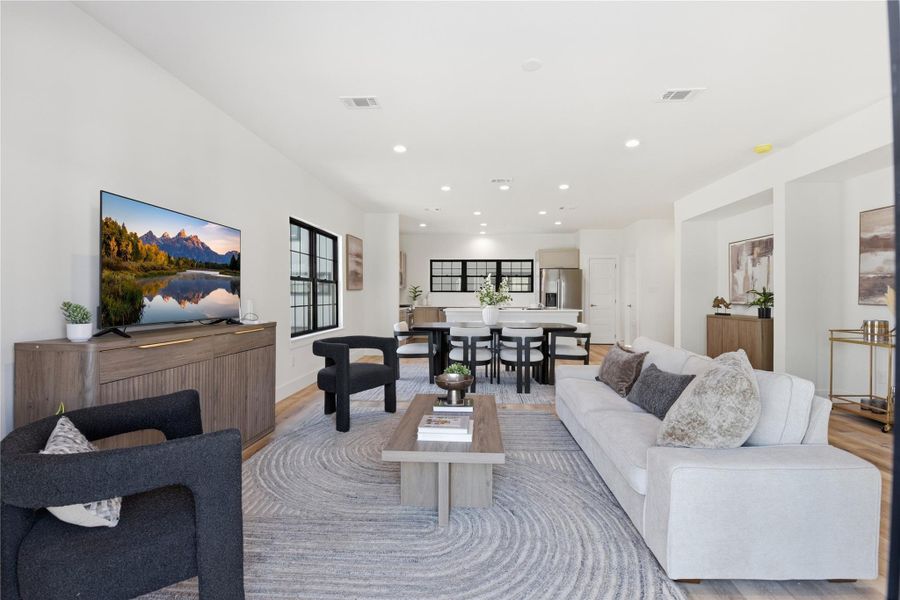 The space is well-lit with recessed lighting and natural light from large windows.