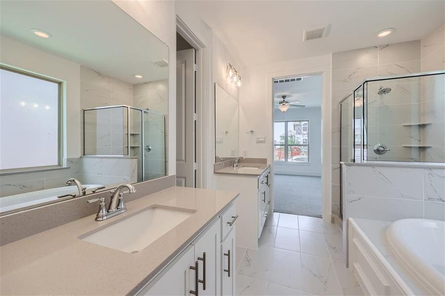 Bathroom featuring tile flooring, vanity, ceiling fan, and independent shower and bath