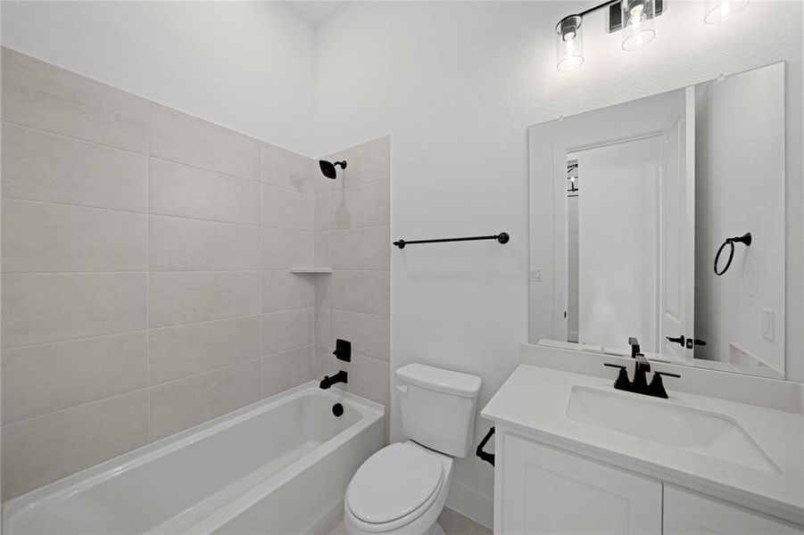 Bathroom featuring bathtub / shower combination and vanity Bathroom featuring bathtub / shower combination and vanity