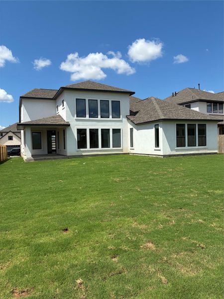 Front exterior of a new home in Santa Rita Ranch, Liberty Hill, TX, highlighting curb appeal (Image 13). Front exterior of a new home in Santa Rita Ranch, Liberty Hill, TX, highlighting curb appeal (Image 13).