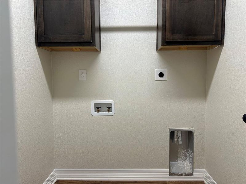 Washroom with hookup for an electric dryer, washer hookup, and cabinet space Washroom with hookup for an electric dryer, washer hookup, and cabinet space