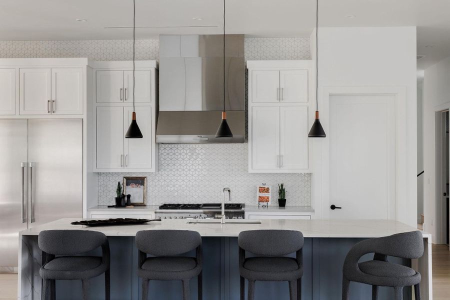 The gourmet kitchen features custom cabinetry, stone surfaces, and a full suite of premium built-in appliances, all centered around a generous island designed for gathering. The gourmet kitchen features custom cabinetry, stone surfaces, and a full suite of premium built-in appliances, all centered around a generous island designed for gathering.