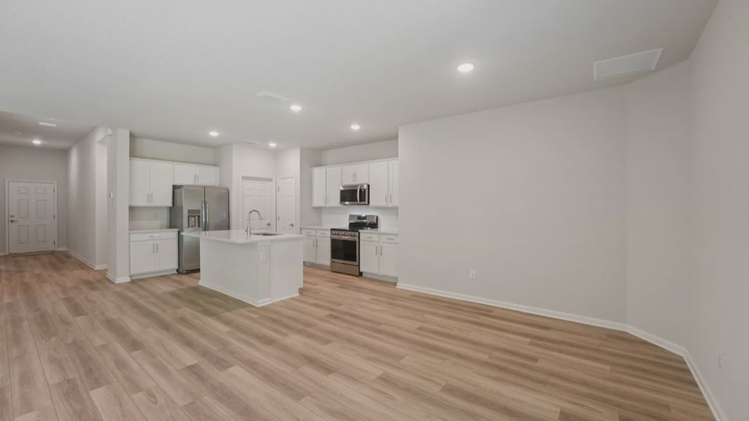 Experience elegance with quartz counters, sleek cabinetry, and luxury vinyl flooring in Palm Coast.