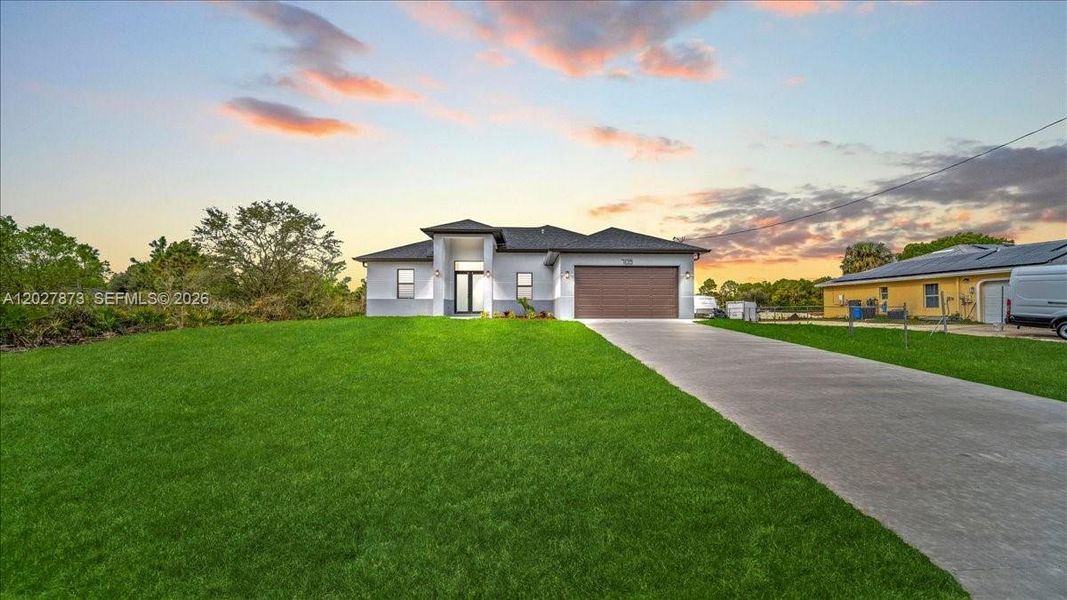 Front exterior of a new home in , Lehigh Acres, FL, highlighting curb appeal (Image 21).