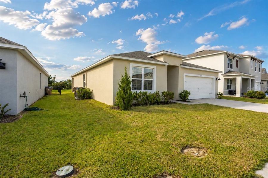 Front exterior of a new home in Harmony West, St. Cloud, FL, highlighting curb appeal (Image 26).