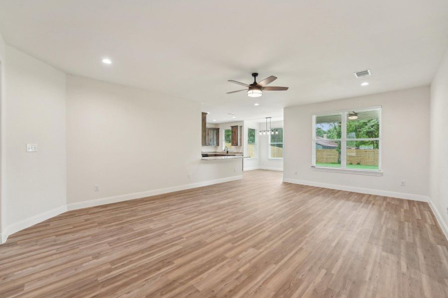 Living room featuring Vinyl Wood Plank floor, baseboards, visible vents, recessed lighting, and ceiling fan Living room featuring Vinyl Wood Plank floor, baseboards, visible vents, recessed lighting, and ceiling fan