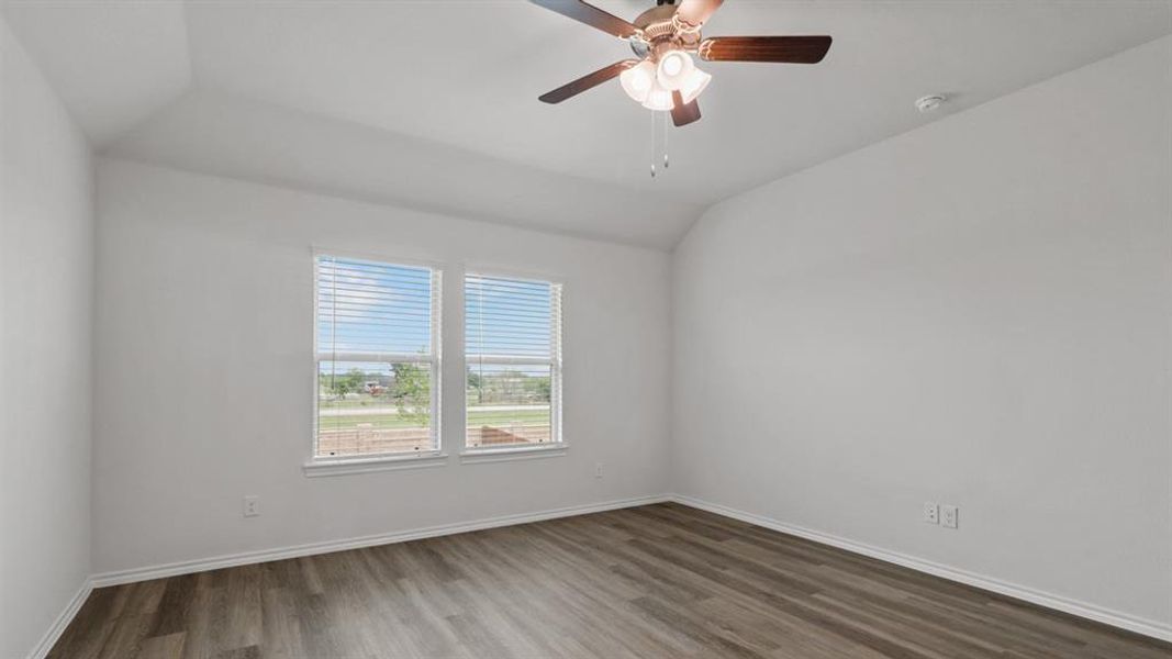 Bright interior featuring wood-finish flooring and a ceiling fan with integrated lighting Bright interior featuring wood-finish flooring and a ceiling fan with integrated lighting