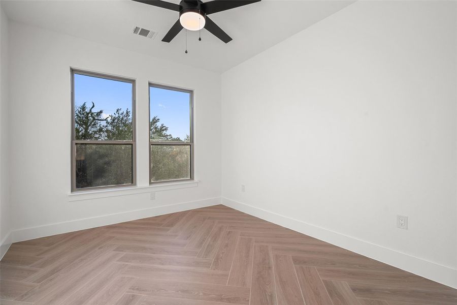 Unfurnished room with baseboards and ceiling fan