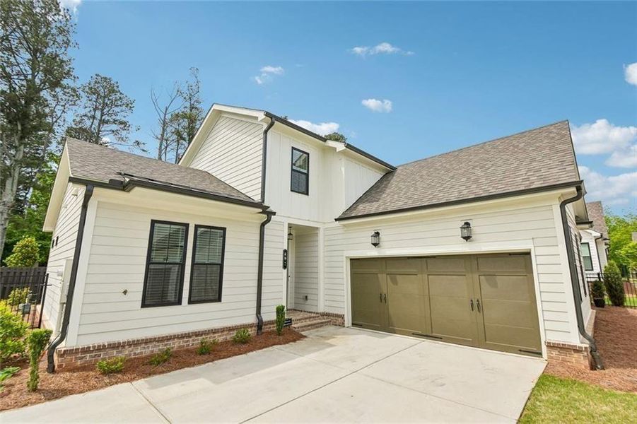 Front exterior of a new home in Promenade at Sawnee Village, Cumming, GA, highlighting curb appeal (Image 2). Front exterior of a new home in Promenade at Sawnee Village, Cumming, GA, highlighting curb appeal (Image 2).