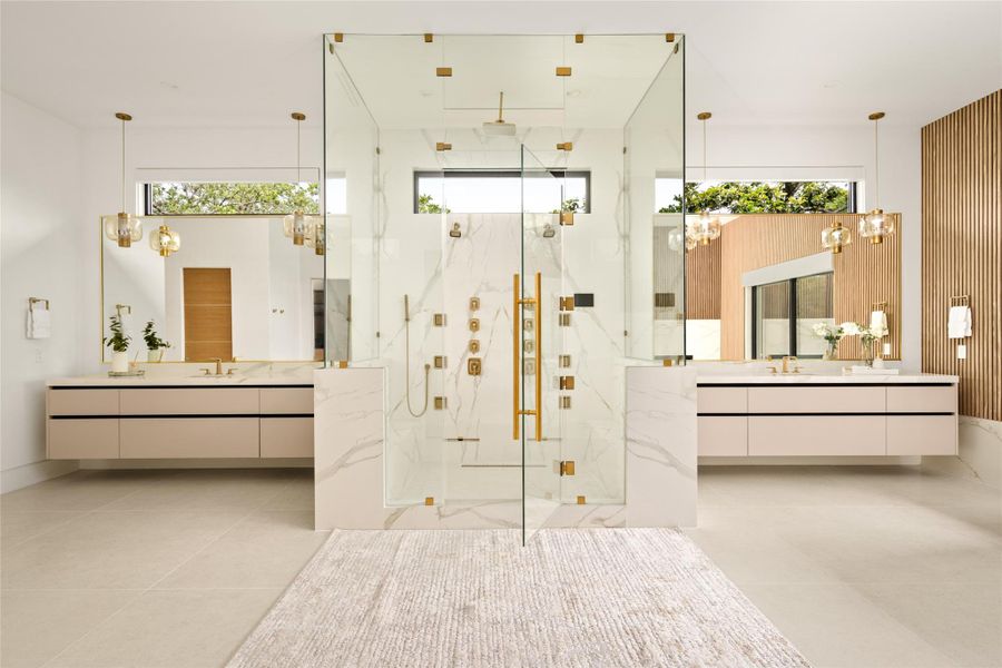 Spa-like primary bath with a striking central glass shower and dual vanities in a perfectly balanced layout.