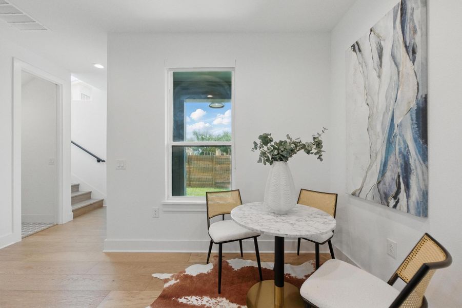 Sitting room with light wood-style flooring, stairs, and recessed lighting Sitting room with light wood-style flooring, stairs, and recessed lighting