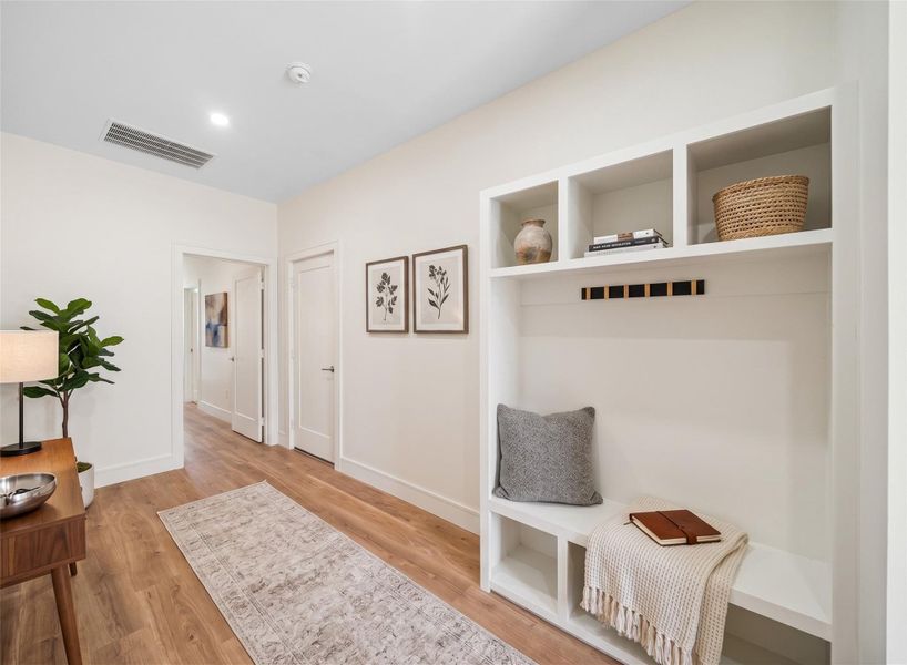 Virtually Staged - Hallway featuring wide-plank engineered oak flooring and built-in shelving, shown with a suggested seating arrangement. Virtually Staged - Hallway featuring wide-plank engineered oak flooring and built-in shelving, shown with a suggested seating arrangement.