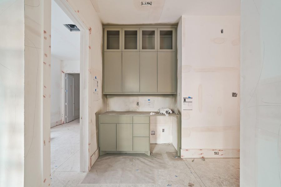 A convenient wet bar with beverage fridge sits just around the corner!