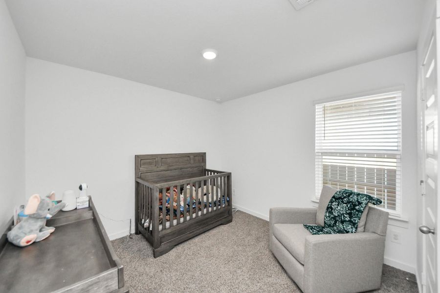 Another secondary bedroom has plenty of space for a queen sized bed and also features a walk-in style closet.