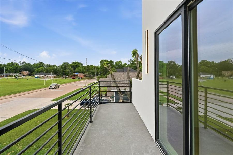 Balcony featuring concrete flooring and modern black metal railings Balcony featuring concrete flooring and modern black metal railings