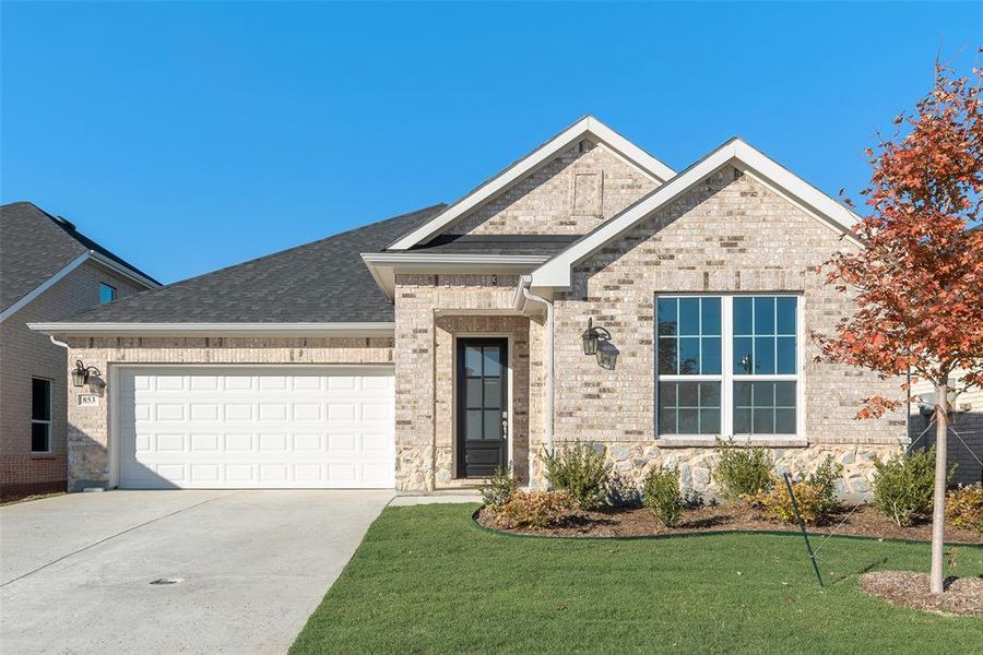 Front exterior of a new home in Wildflower Ranch, Justin, TX, highlighting curb appeal (Image 1).