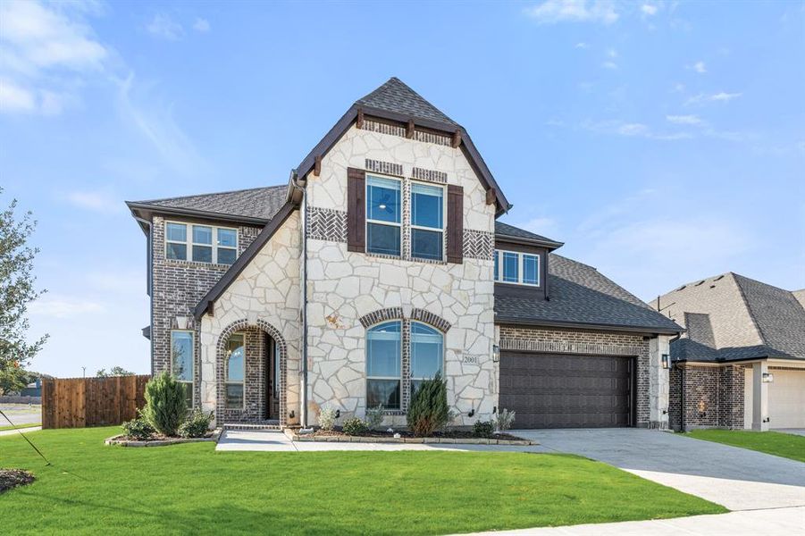 Front exterior of a new home in Meadow Vista 60-65, Anna, TX, highlighting curb appeal (Image 2). Front exterior of a new home in Meadow Vista 60-65, Anna, TX, highlighting curb appeal (Image 2).