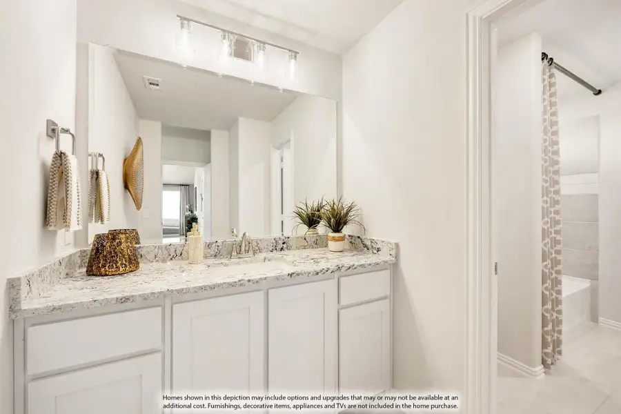 Bathroom vanity with white cabinets, granite countertop, large mirror, and separate tub area visible through doorway