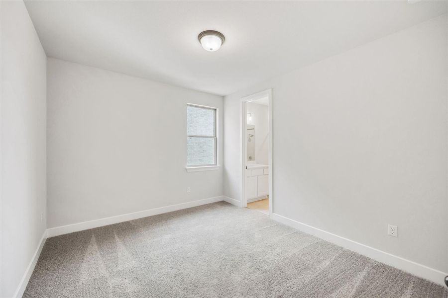 Unfurnished room with light carpet and baseboards Unfurnished room with light carpet and baseboards