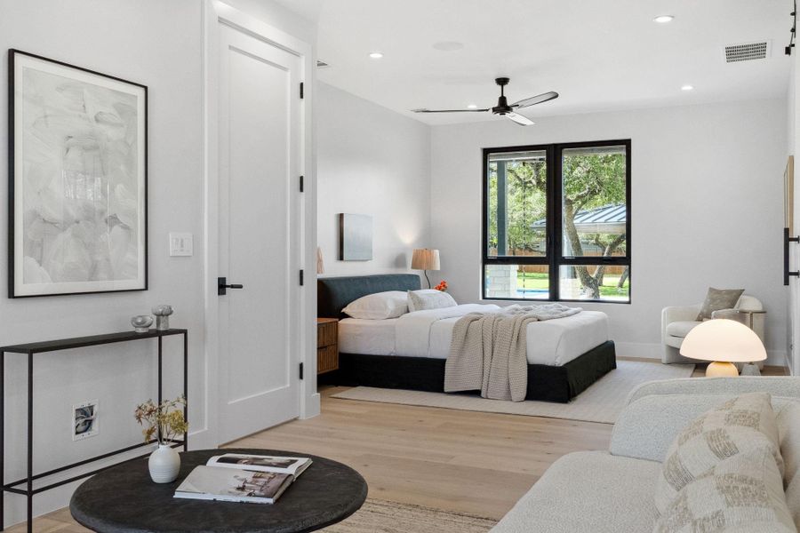 Expansive primary bedroom featuring a comfortable sitting area.