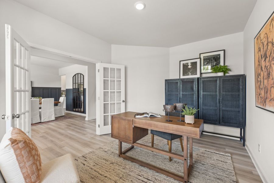 A living room with a table and chairs.