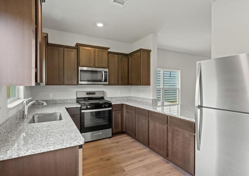 The kitchen of the Piper has gorgeous wood cabinetry and sprawling granite countertops.