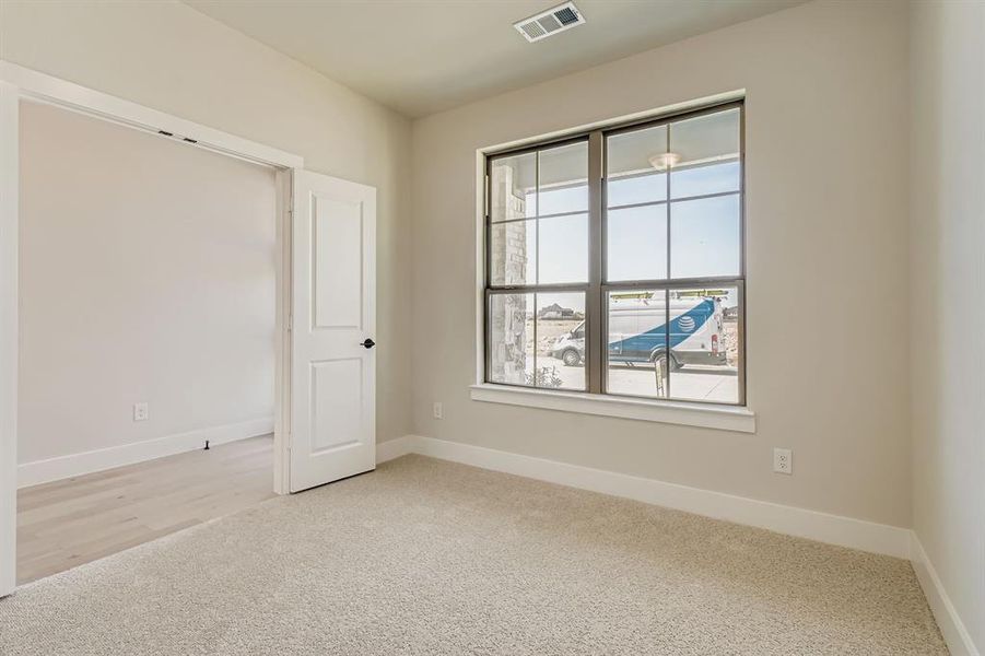 Unfurnished room featuring carpet and baseboards