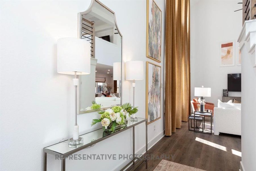 Hallway featuring dark wood-style flooring and baseboards