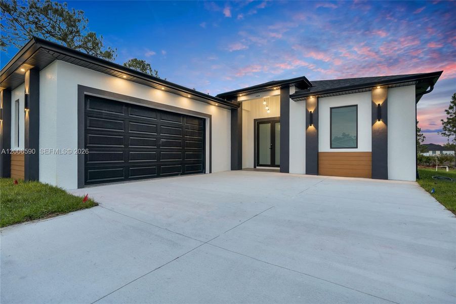 Front exterior of a new home in , Lehigh Acres, FL, highlighting curb appeal (Image 30).