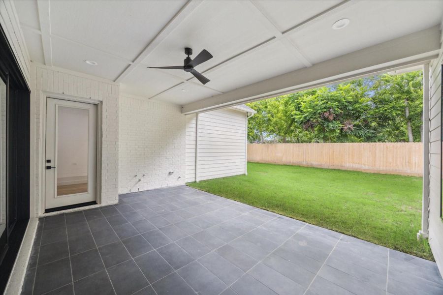 Spacious covered patio with ceiling fan and outdoor hookups—ready for future kitchen build-out or weekend hangouts overlooking the backyard. Spacious covered patio with ceiling fan and outdoor hookups—ready for future kitchen build-out or weekend hangouts overlooking the backyard.