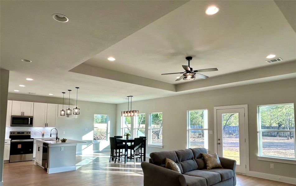 Open concept kitchen, dining, and living areas. Open concept kitchen, dining, and living areas.