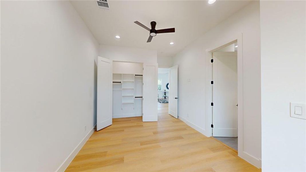 Corridor featuring light wood-type flooring and recessed lighting