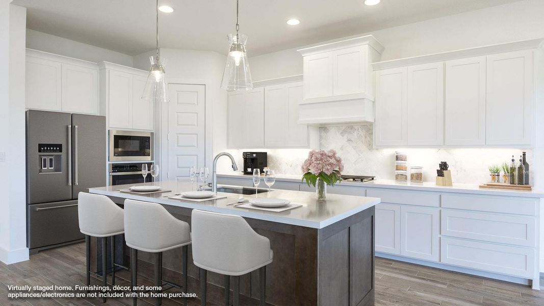 Kitchen featuring stainless steel appliances, wood finished floors, white cabinets, a center island with sink, and recessed lighting Kitchen featuring stainless steel appliances, wood finished floors, white cabinets, a center island with sink, and recessed lighting
