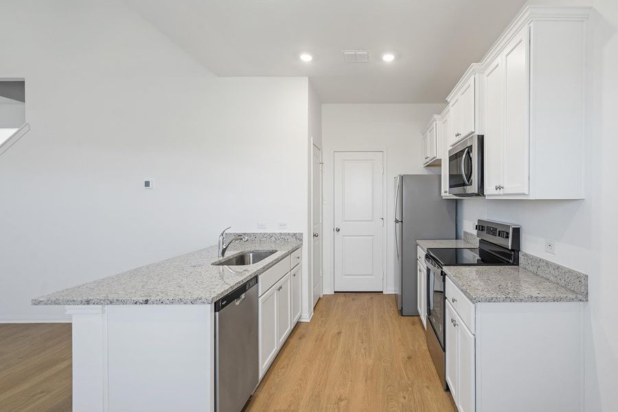 Kitchen includes energy efficient Whirlpool® kitchen appliances. Kitchen includes energy efficient Whirlpool® kitchen appliances.