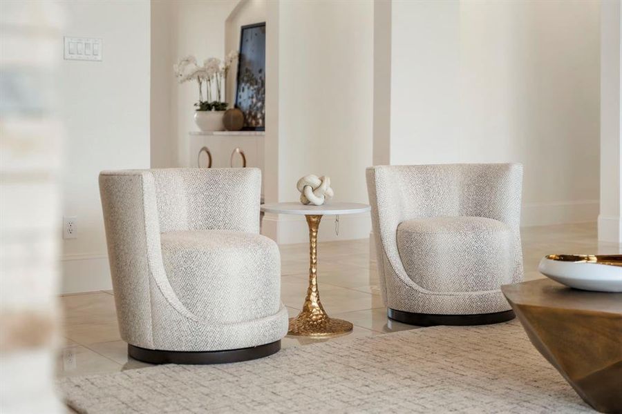 These swivel upholstered armchairs and stylish white side table with a golden base are beautiful and available at Star Furniture. =