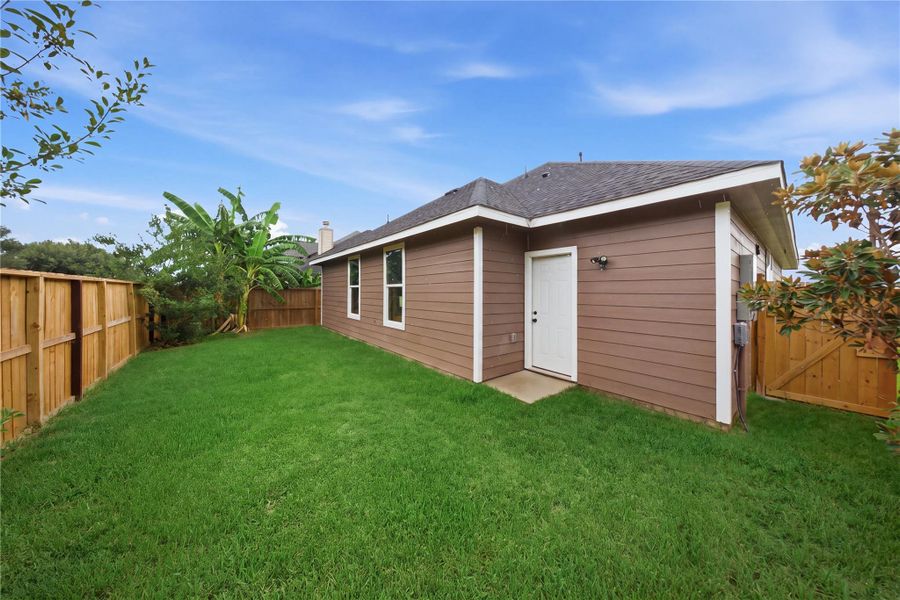 Charming patio with lush greenery, perfect for relaxing or entertaining.