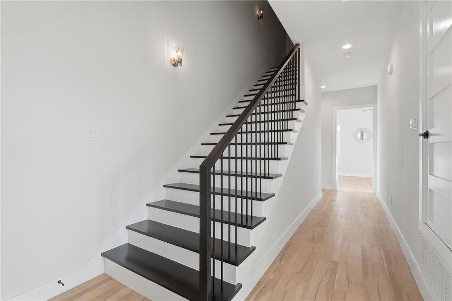 Stairs featuring wood finished floors and recessed lighting Stairs featuring wood finished floors and recessed lighting