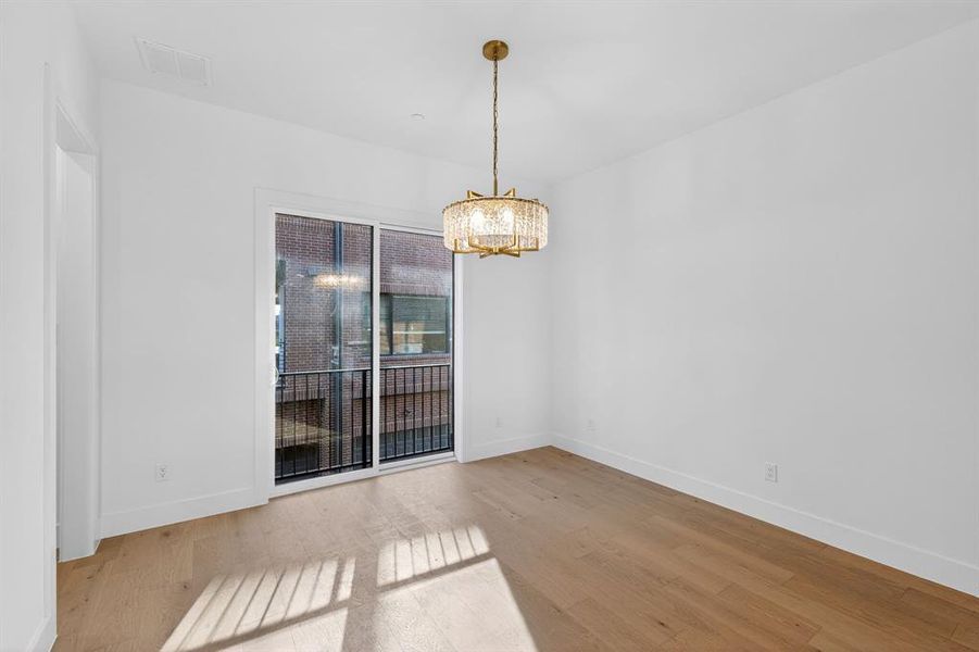 Dining room featuring light wood finished floors and hanging lights