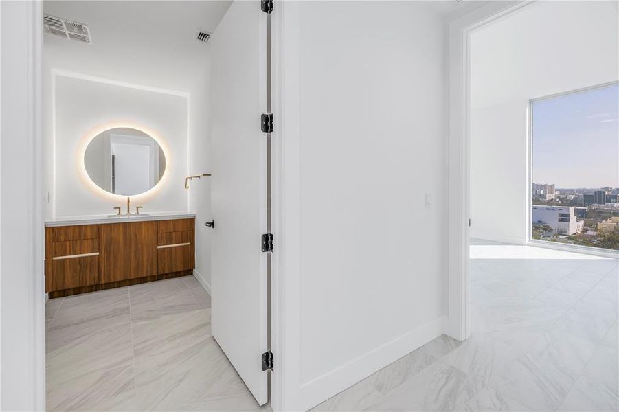 Entrance into primary suite - gorgeous bathroom and an exciting view from the bedroom