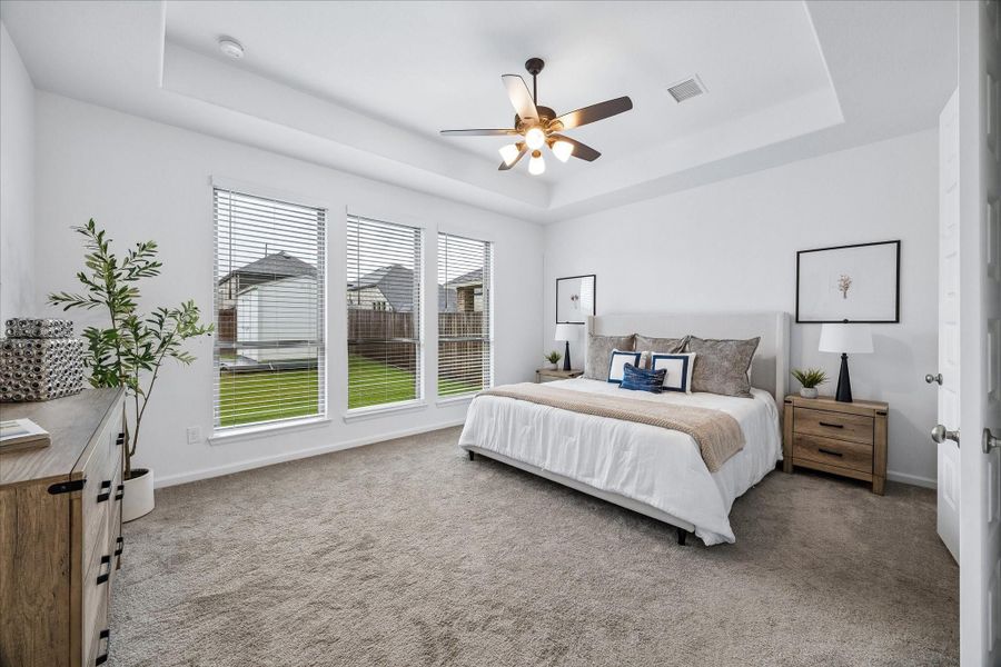 You’ll have sweet dreams in this posh first-floor owner’s retreat with a raised tray ceiling, cooling fan, soft carpet, and peaceful backyard views. The massive walk-in closet and spa-like ensuite make this private retreat feel both luxurious and easy to love.