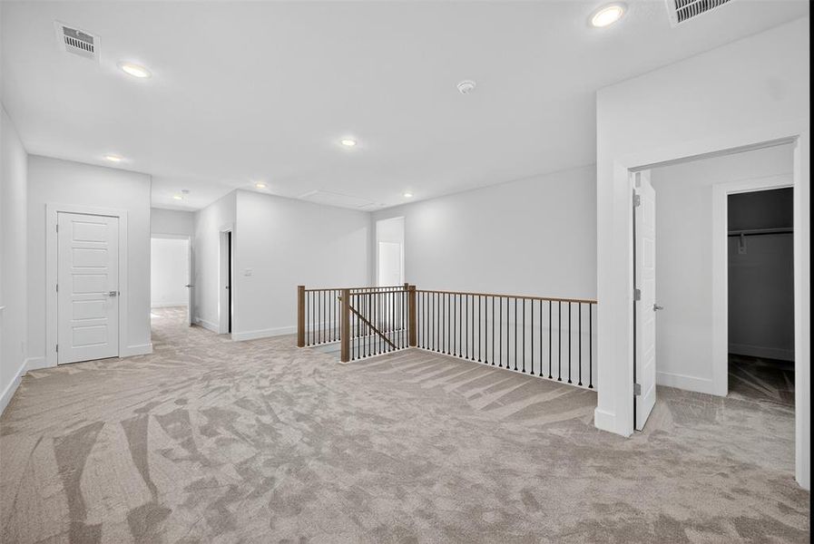 Empty room featuring light colored carpet and recessed lighting Empty room featuring light colored carpet and recessed lighting
