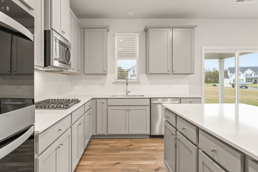 A kitchen with white cabinets. A kitchen with white cabinets.