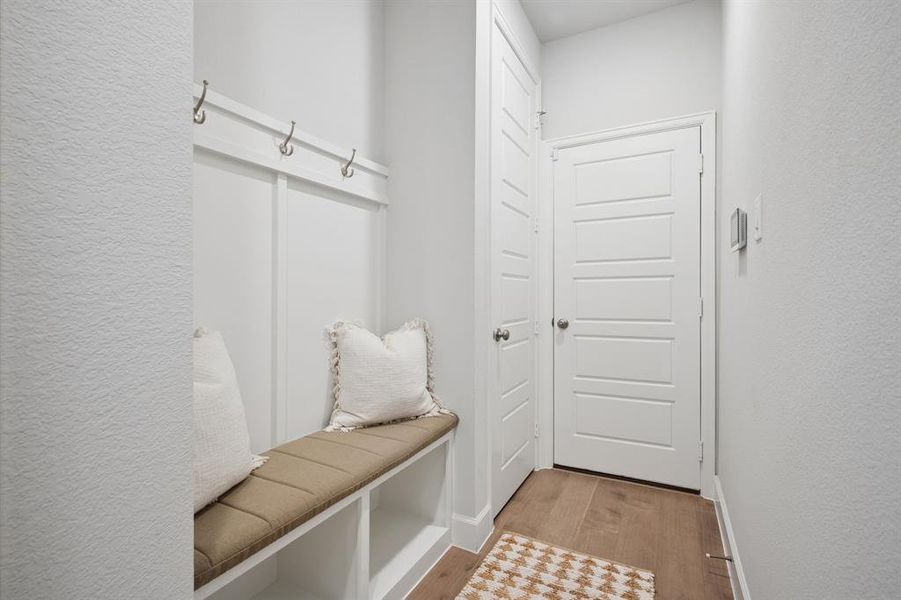 Built-in mudroom bench with storage cubbies and coat hooks