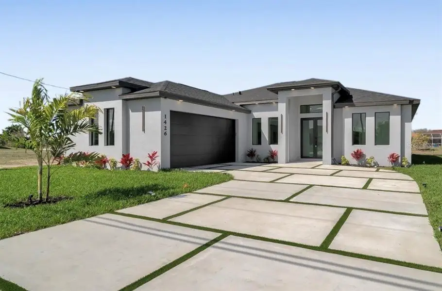 Front exterior of a new home in , Cape Coral, FL, highlighting curb appeal (Image 1). Front exterior of a new home in , Cape Coral, FL, highlighting curb appeal (Image 1).