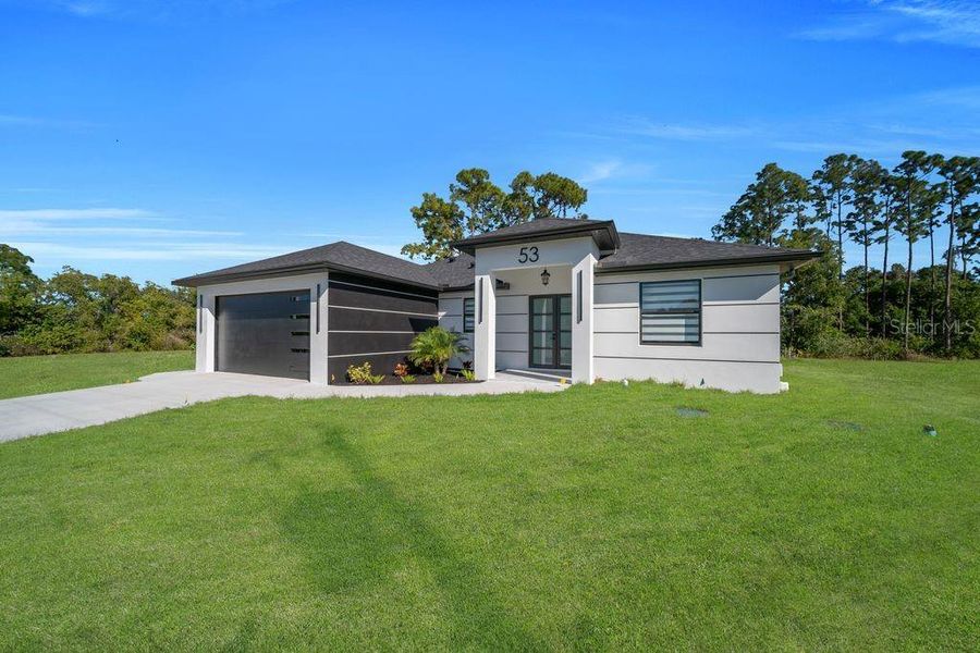 Front exterior of a new home in , Lehigh Acres, FL, highlighting curb appeal (Image 18).